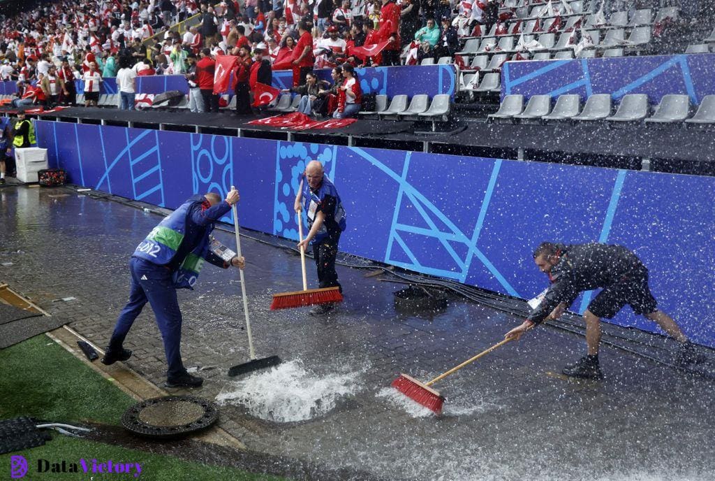 Stadium staff look to clear flooding during Turkey vs Georgia at Euro 2024