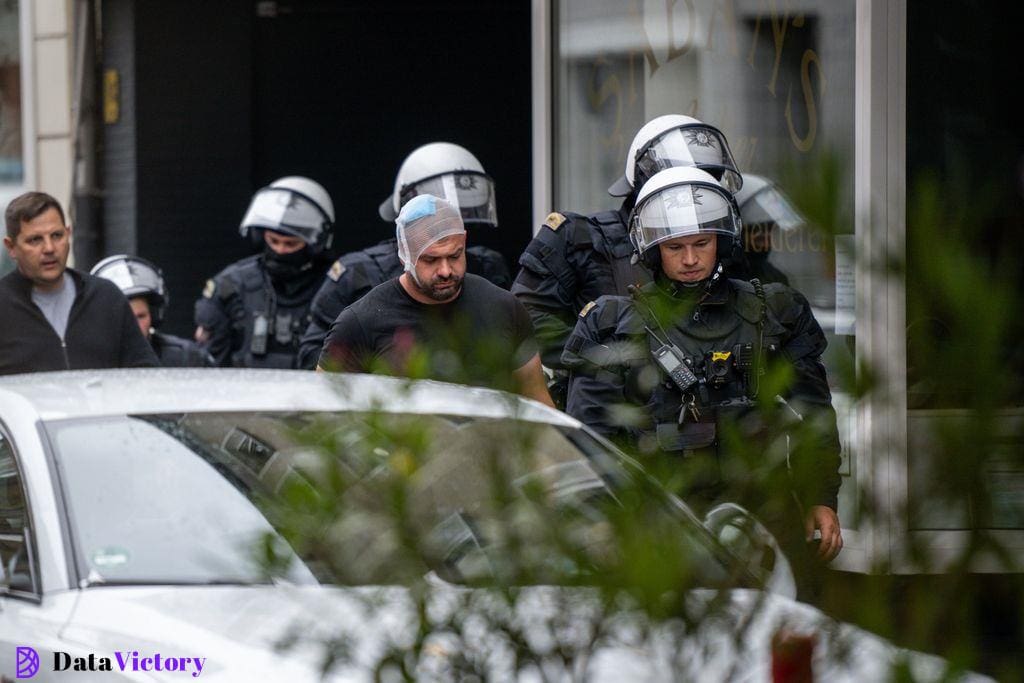 Police secure an area outside a restaurant where a Serbia fan was attacked ahead of Serbia's game against England at Euro 2024.