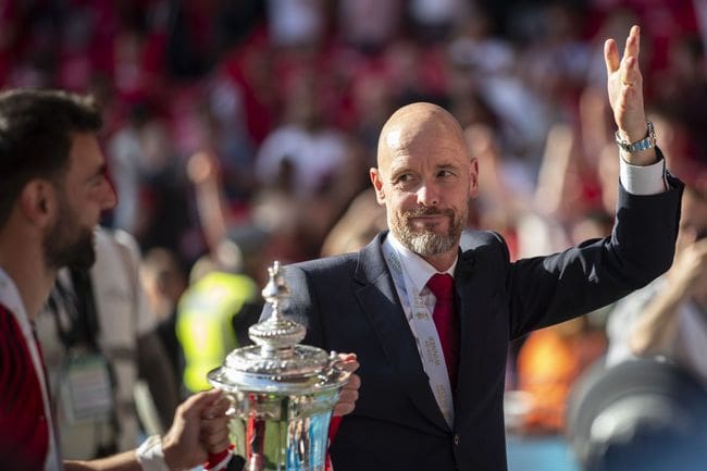 Erik ten Hag celebrates with the FA Cup trophy after Manchester United's win over Manchester City at Wembley in May 2024.