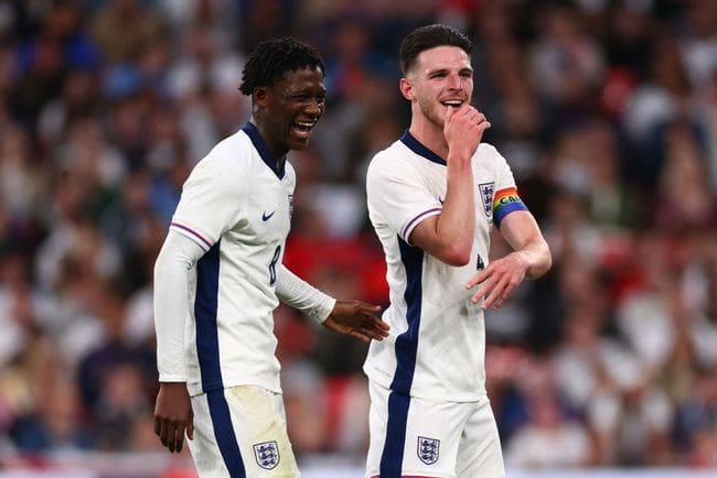 Kobbie Mainoo laughs alongside Declan Rice of England during the international friendly match between England and Iceland at Wembley Stadium on June 7, 2024 in London, England.(Photo by Marc Atkins/Getty Images)