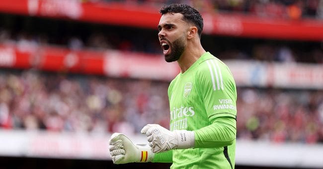 Arsenal goalkeeper David Raya celebrates after Bukayo Saka scored their sides first goal during the Premier League match between Arsenal FC and Tottenham Hotspur at Emirates Stadium on September 24, 2023 in London, England.