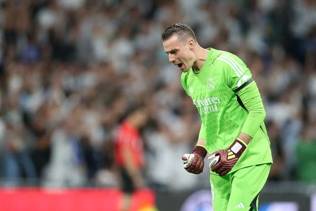 Andriy Lunin of Real Madrid CF celebrates after his team mate Vinicius Junior scores the first goal during the LaLiga EA Sports match between Real Madrid CF and FC Barcelona at Estadio Santiago Bernabeu on April 21, 2024 in Madrid, Spain.