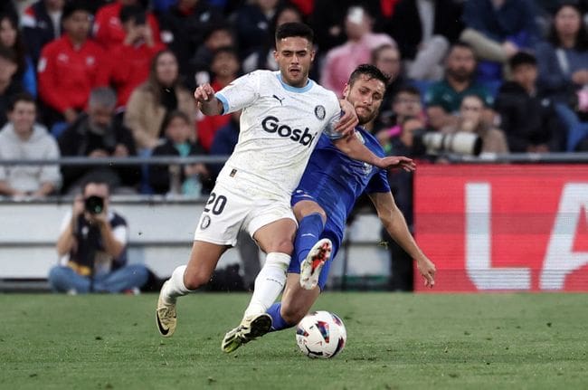 Girona's Brazilian defender #20 Yan Couto is tackled by Getafe's Spanish midfielder #09 Oscar Rodriguez during the Spanish league football match between Getafe CF and Girona FC at the Col. Alfonso Perez stadium in Getafe on March 16, 2024. (Photo by Thomas COEX / AFP) (Photo by THOMAS COEX/AFP via Getty Images) Manchester City