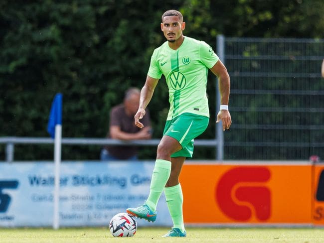 Maxence Lacroix of VfL Wolfsburg plays the ball during the pre-season friendly match between VfL Wolfsburg and Lille OSC on July 24, 2024 in Rheda-Wiedenbruck, Germany.