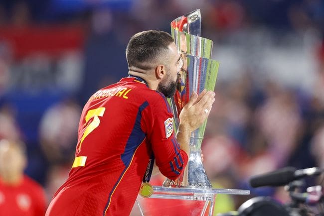 Spain defender Real Madrid Dani Carvajal kisses the UEFA Nations League trophy in 2023.