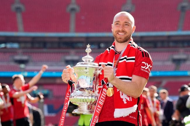 Christian Eriksen of Manchester United holds the FA Cup trophy, 2024