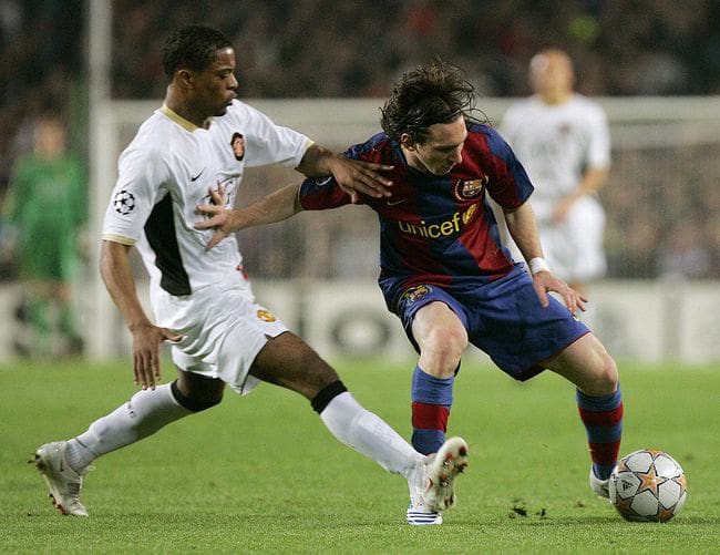 Barcelona's Argentinan Lionel Messi (R) holds off Manchester United's Partrice Evra during a UEFA Champions League semi-final first leg football match at the Nou Camp stadium in Barcelona on April 23, 2008. AFP PHOTO/JOSEP LAGO (Photo credit should read JOSEP LAGO/AFP via Getty Images)