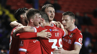 Andy Cannon of Wrexham celebrates scoring with Wrexham teammates